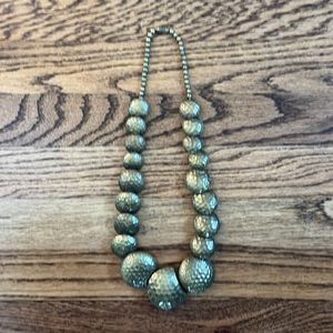 Vintage brass like hammered metal statement necklace.